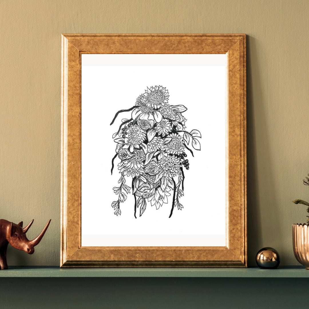 Wild flower ink drawing framed leaning on a mantle fireplace