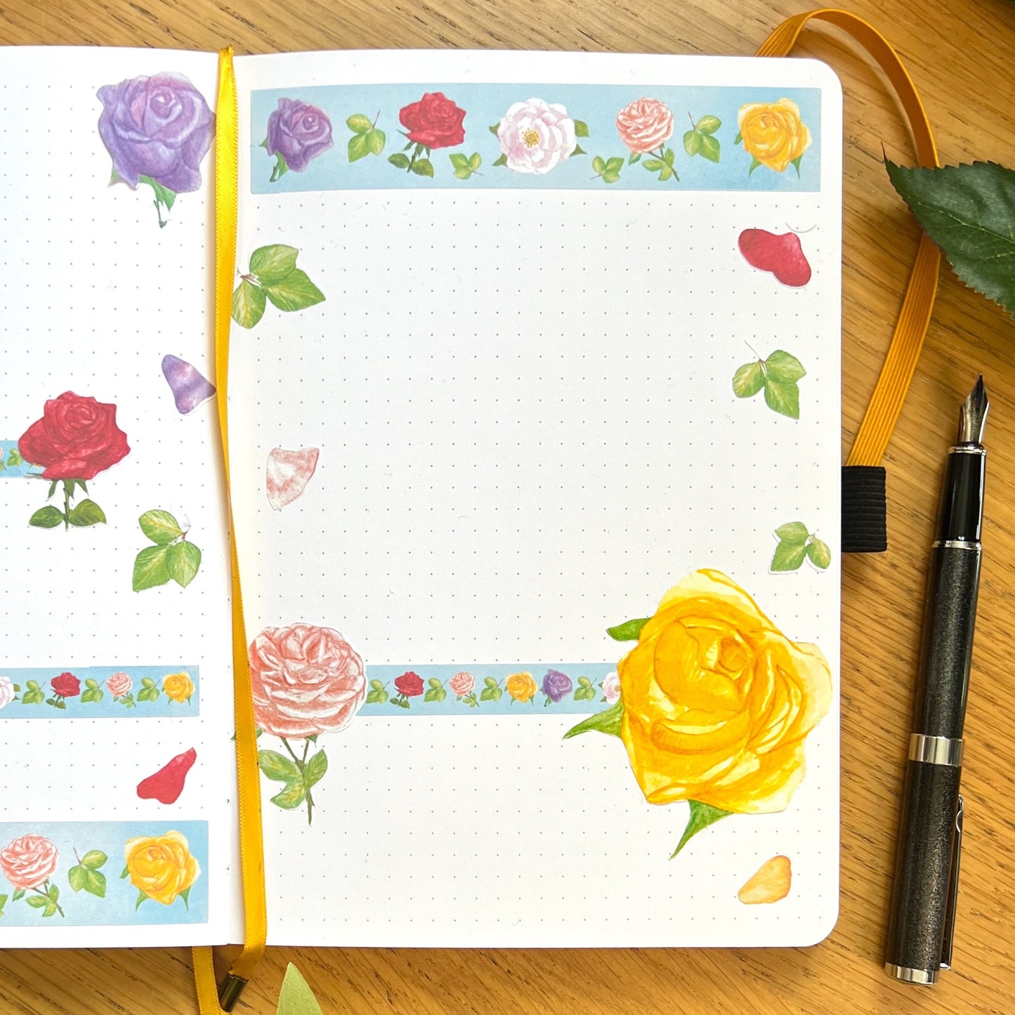Journal page decorated with die cut, Washi strips and decorative stickers of roses in a variety of vibrant colours
