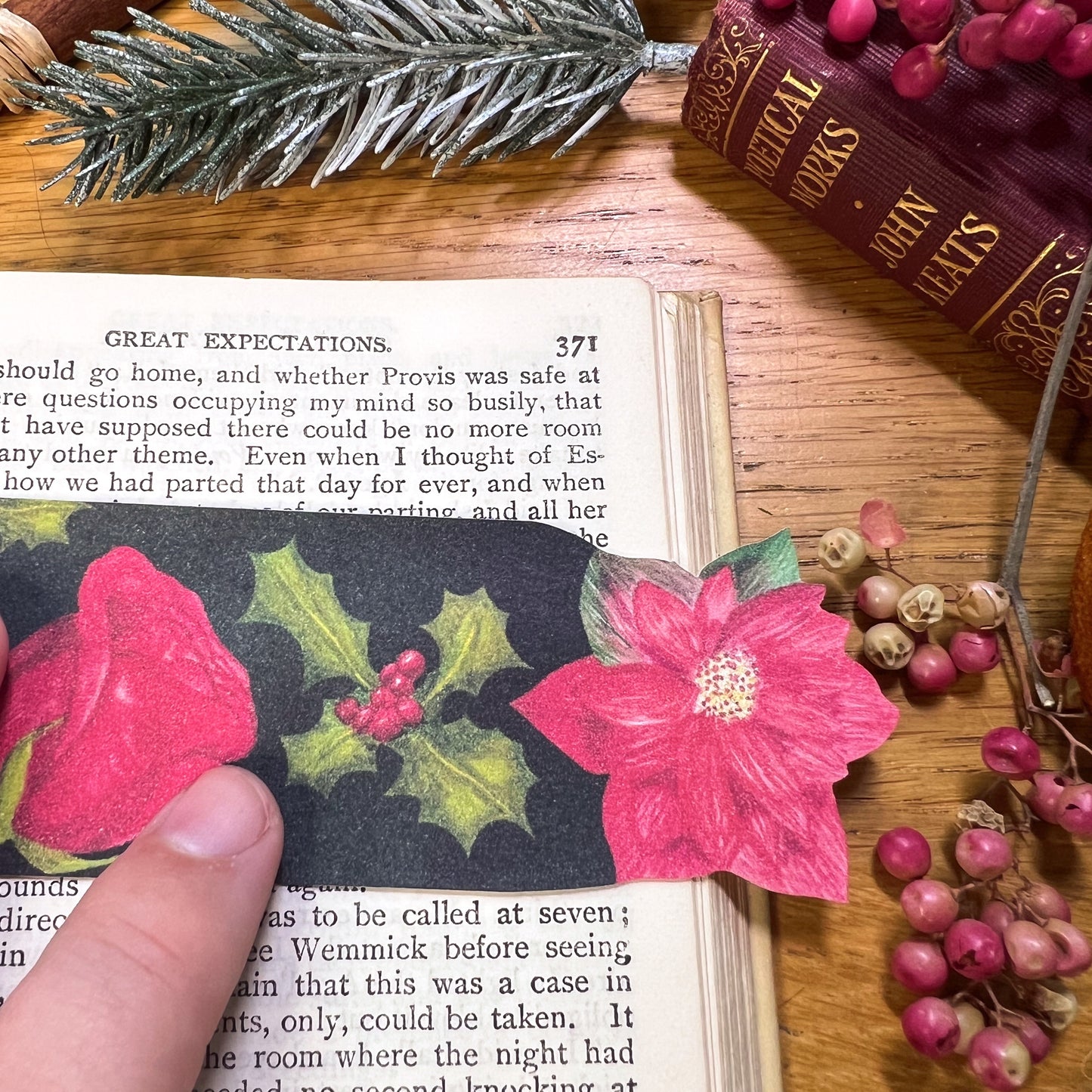 Winters bloom bookmark close up used in book. Bookmark has been cut out at the top to the shape of Red poinsettia