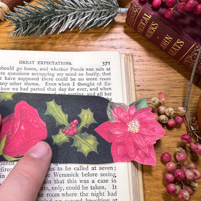 Winters bloom bookmark close up used in book. Bookmark has been cut out at the top to the shape of Red poinsettia