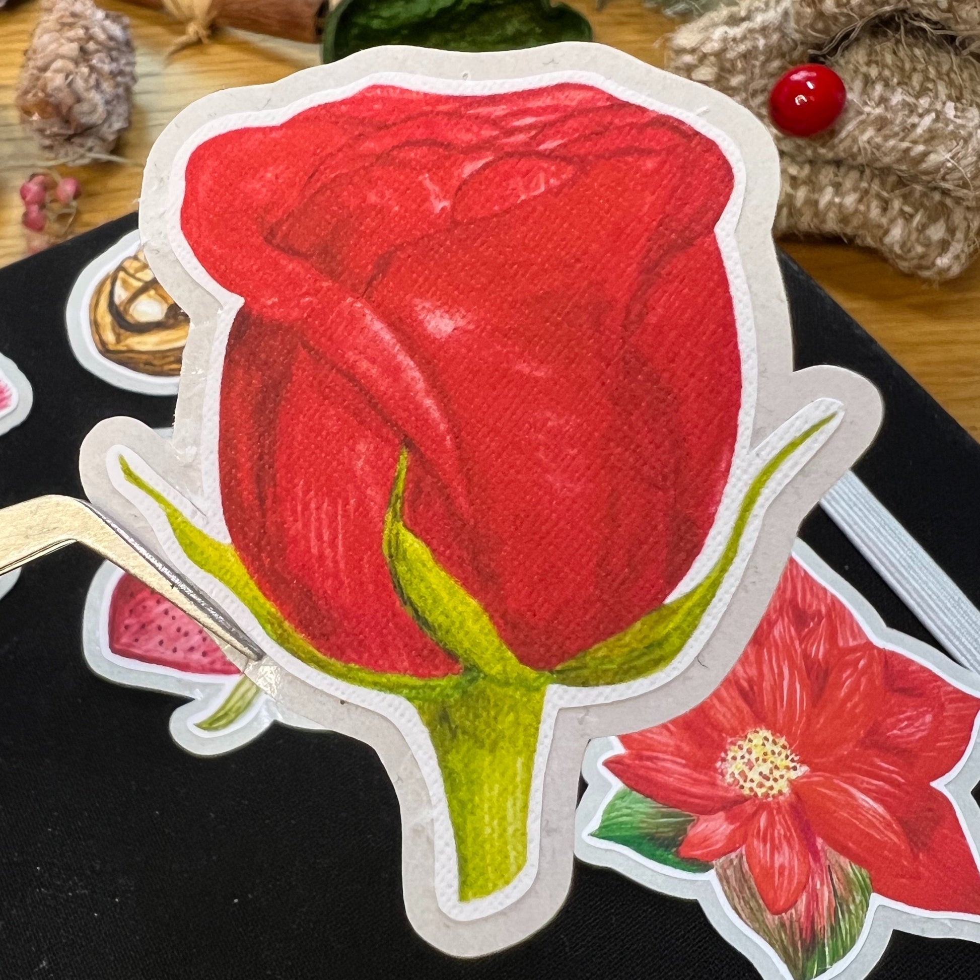 Close up of a red rose tea hybrid bud die cut sticker showing the linen texture that looks like canvas